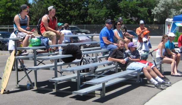 Front view of patrons on bleachers available for rent.