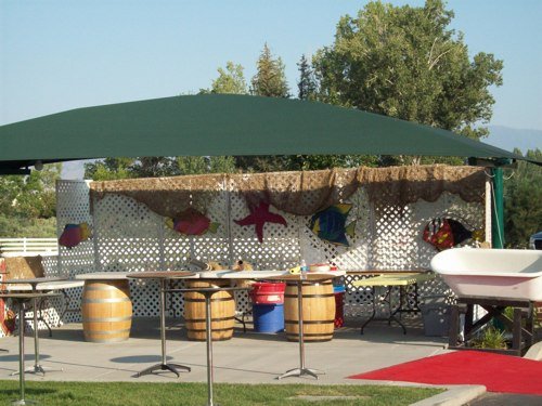Barrels and tropical themed bar for party.