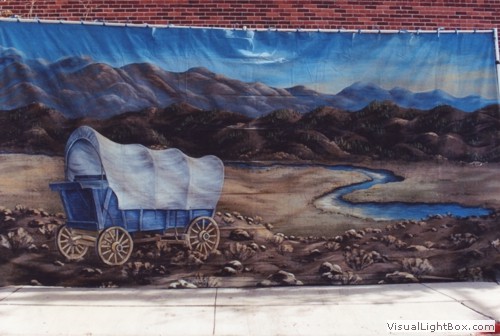 Wagon train themed backdrop for prop rental.